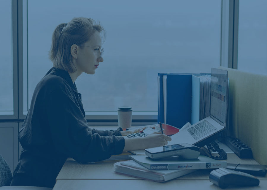 Woman at a desk with a computer
