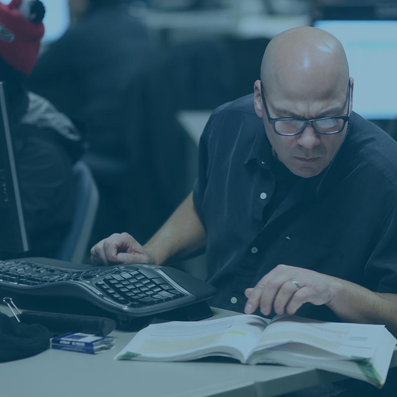 Faculty by a blackboard